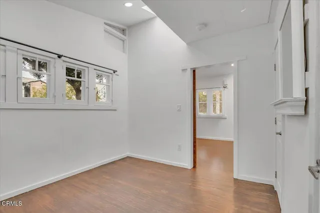 an empty room with windows and closet