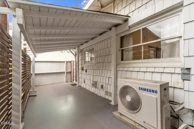 a view of a house with a yard and large tree
