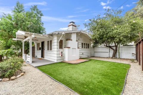 a view of a house with a backyard