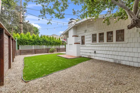 a view of a backyard with a large tree