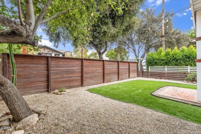 a view of a room with wooden floor and windows