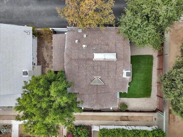 an aerial view of a house with a yard