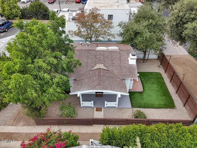an aerial view of a house with a garden and a yard