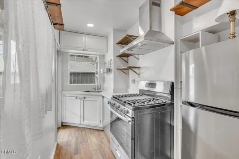 a kitchen with stainless steel appliances granite countertop a stove and a refrigerator