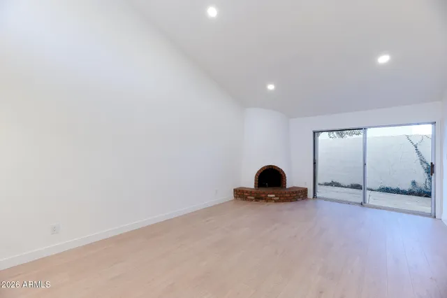 an empty room with closet and a ceiling fan
