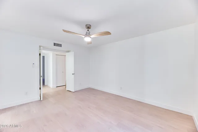 a bathroom with a bathtub shower sink vanity mirror and toilet