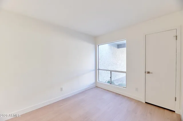 a backyard of a house with plants and outdoor seating
