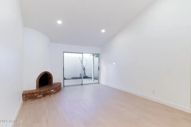 a view of a room with a fireplace and window