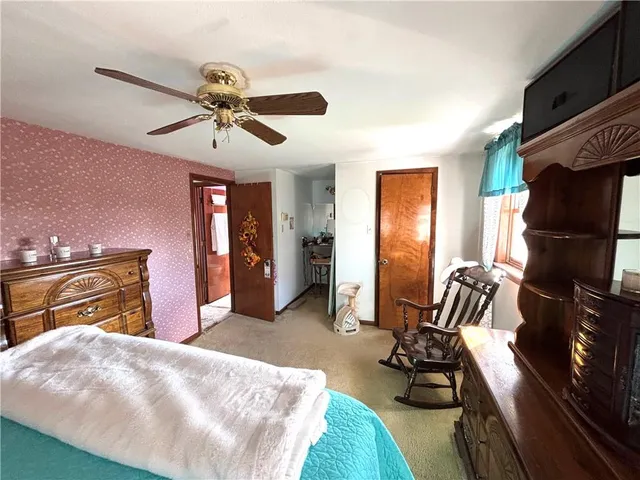 a bedroom with furniture and a window