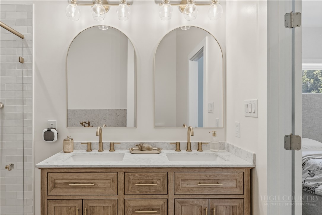355 South River Hills Road Lansing, NC 28643 - Photo 32 of 45 a bathroom with a double vanity sink mirror and