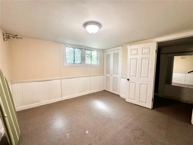 an empty room with closet and bathroom