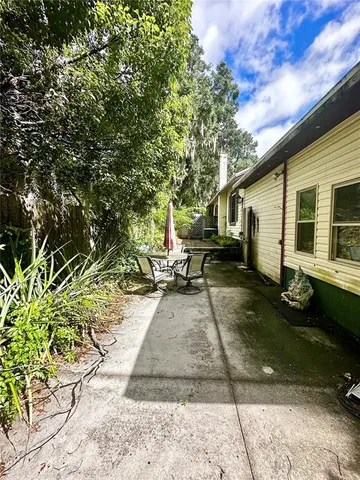 a view of a chair and tables in the patio