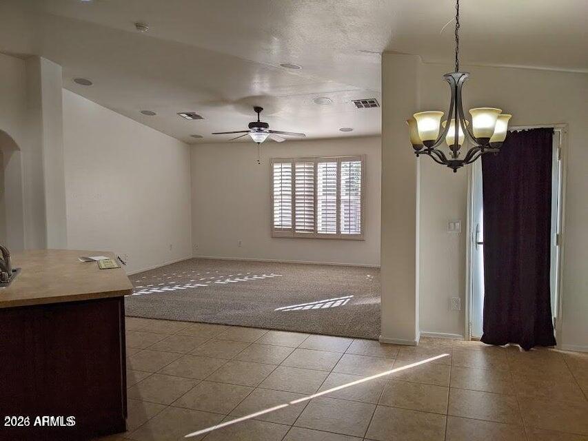 18237 West Bridger Street Surprise, AZ 85388 - Photo 3 of 4 a view of a hallway with granite countertop a chandelier