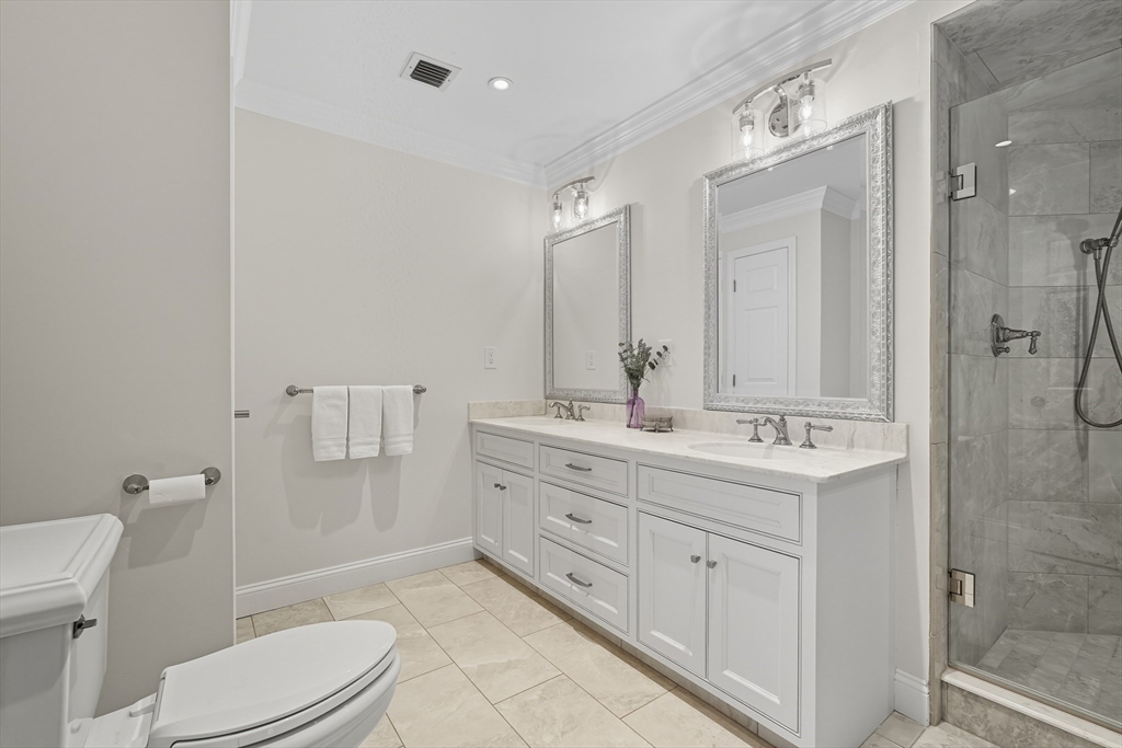 32 Windpath East, Unit 32 West Springfield, MA 01089 - Photo 27 of 40 a bathroom with a double vanity sink toilet mirror and shower
