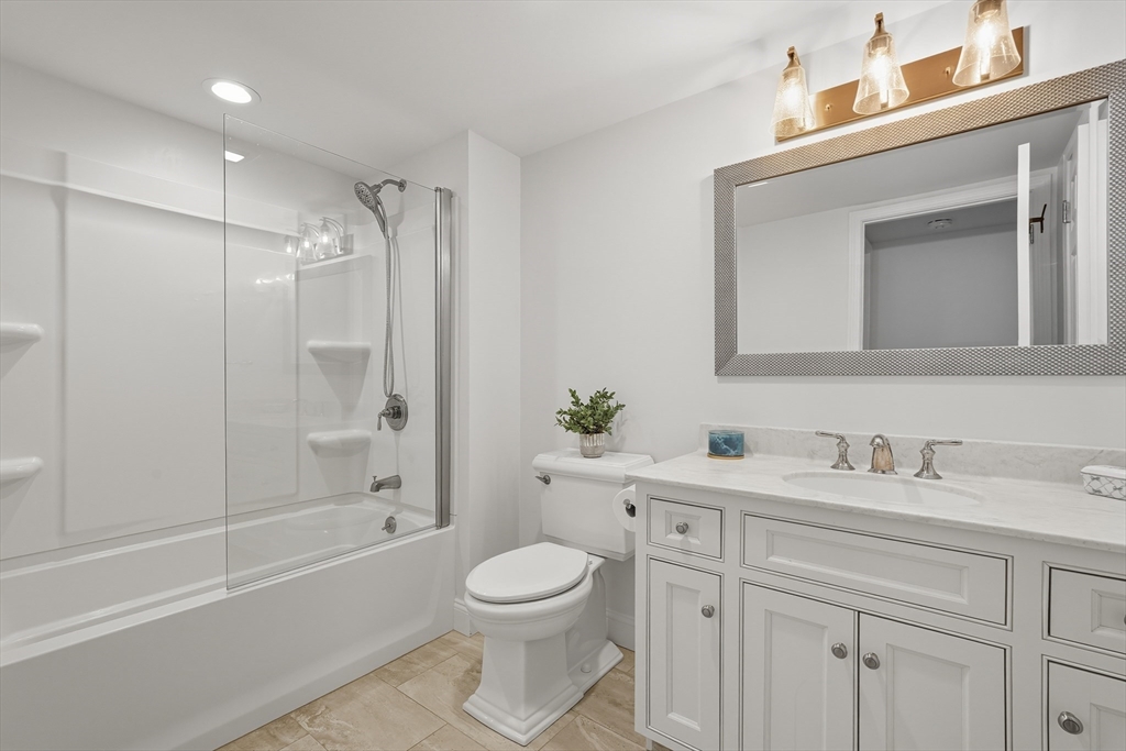 32 Windpath East, Unit 32 West Springfield, MA 01089 - Photo 32 of 40 a bathroom with a toilet a sink a mirror a bathtub and vanity