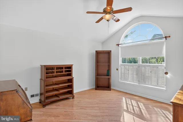 a view of room with hardwood floor and ceiling fan