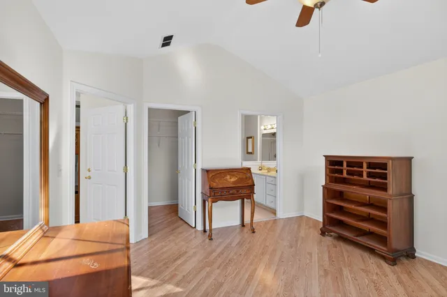 a bedroom with furniture and wooden floor