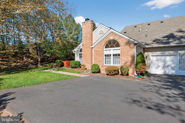 a view of a house with a yard and garage