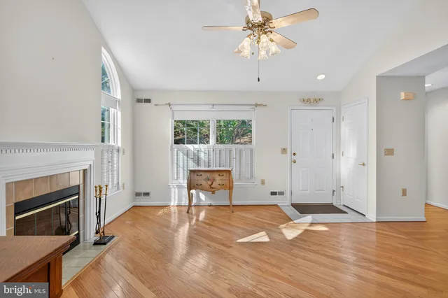 a view of empty room with a fireplace and wooden floor