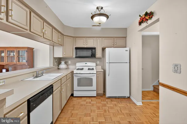 a kitchen with a sink a refrigerator and a stove