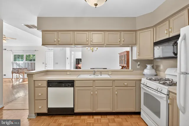 a kitchen with cabinets appliances a sink and a counter space