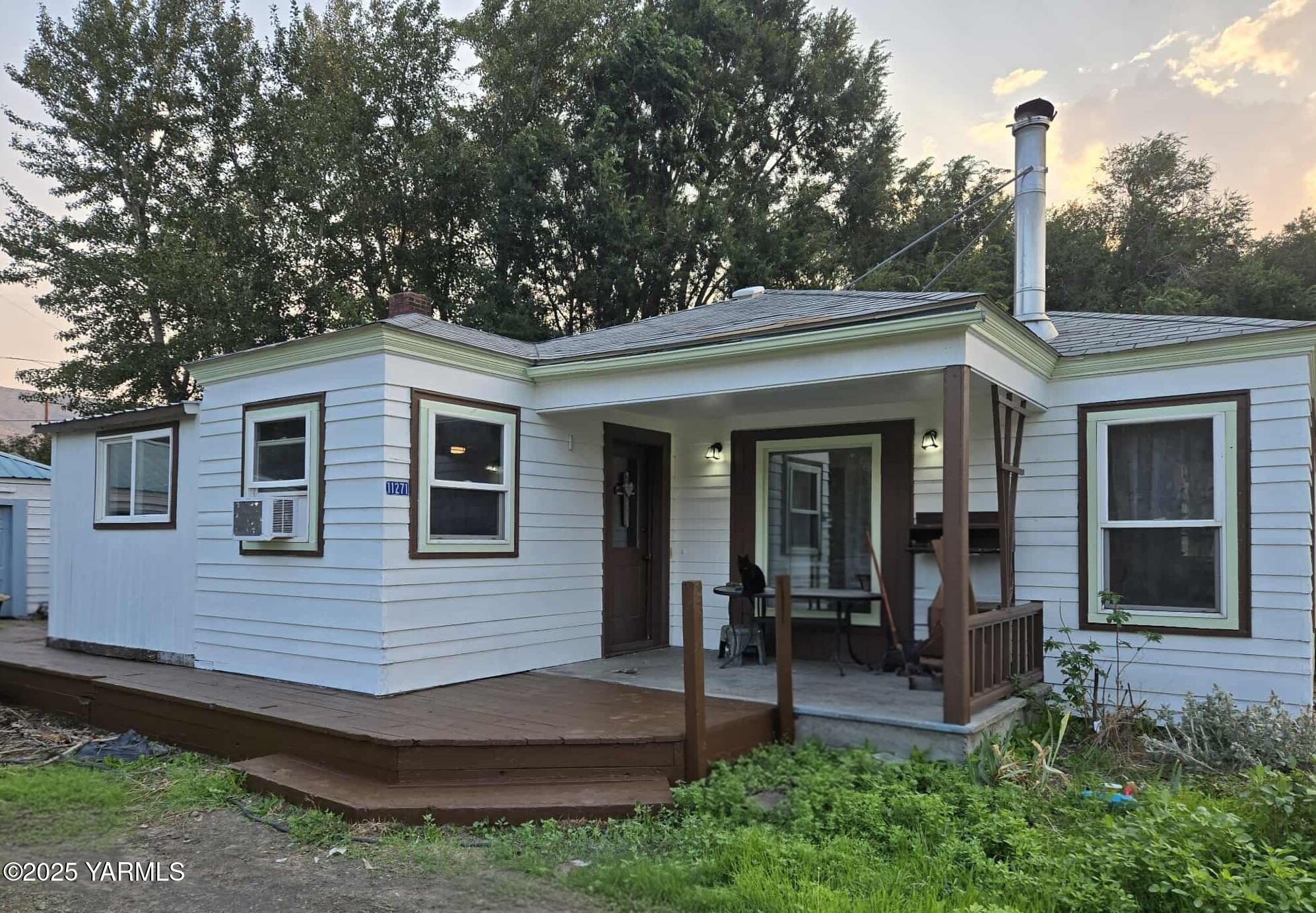 a view of a house with a yard and sitting area