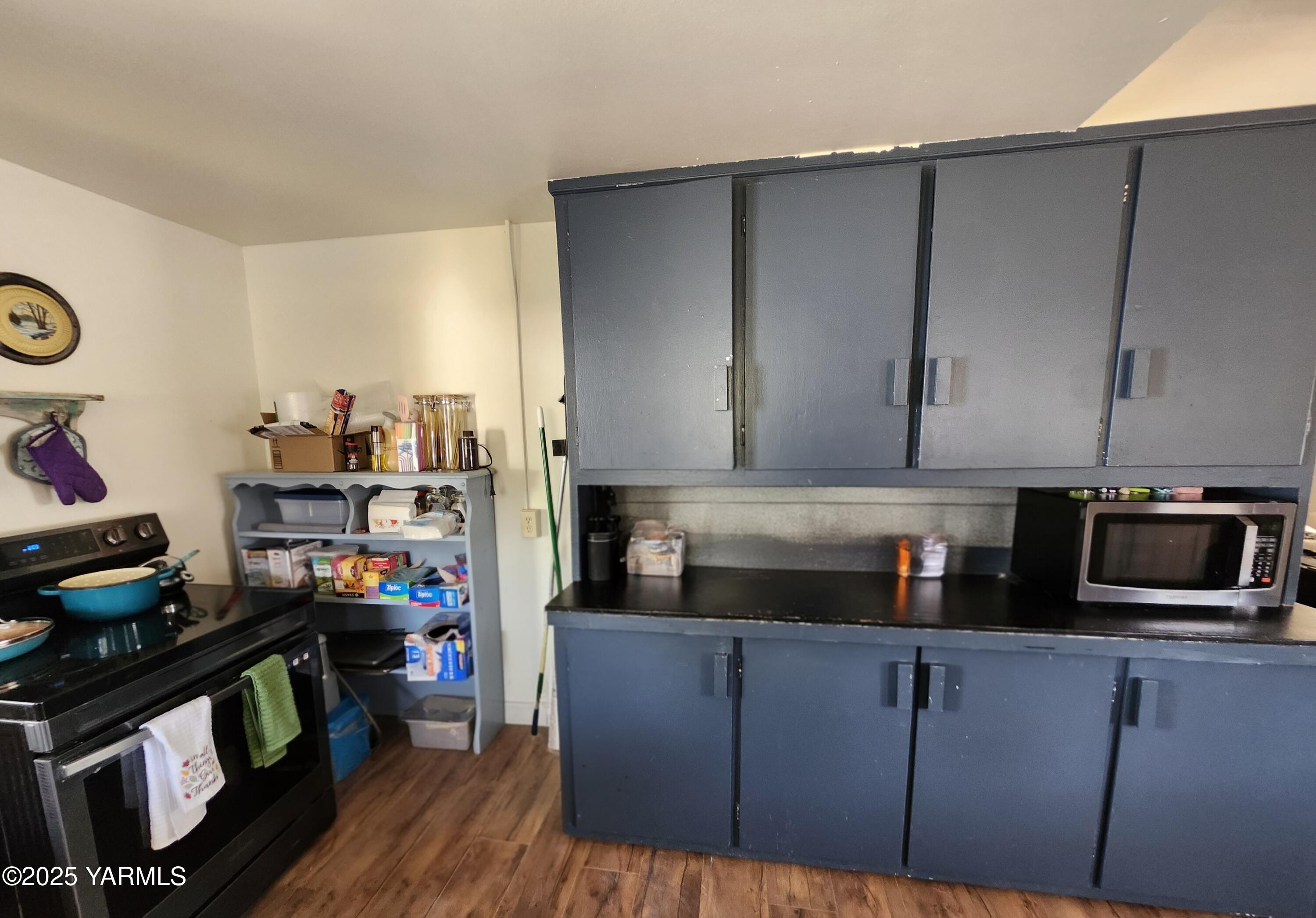 11271 Highway 12 Naches, WA 98937 - Photo 11 of 14 a kitchen with a refrigerator and a stove top oven