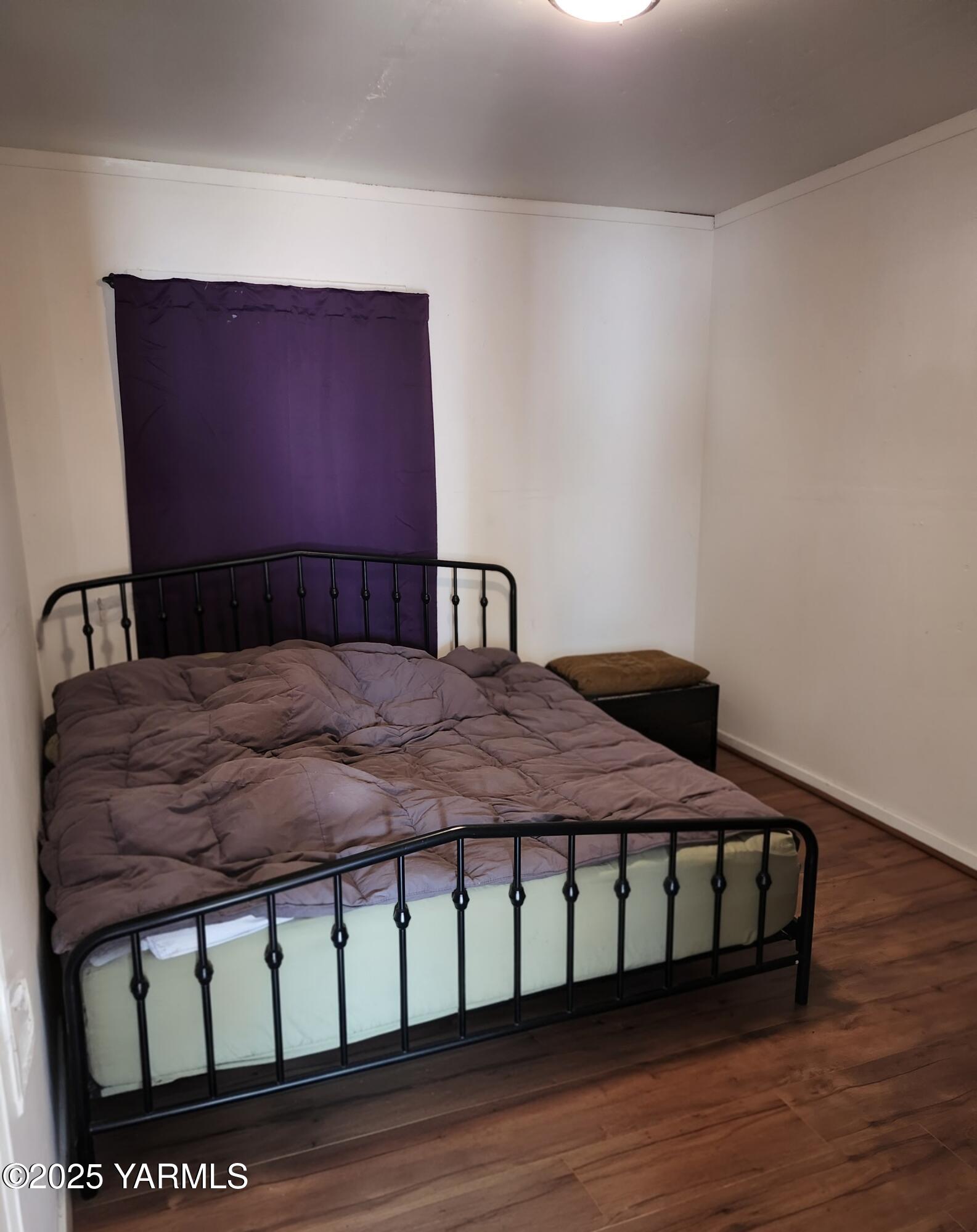 11271 Highway 12 Naches, WA 98937 - Photo 6 of 14 a bedroom with a bed and wooden floor