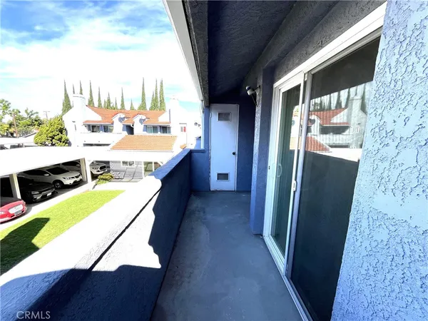 a balcony with furniture and a flat screen tv