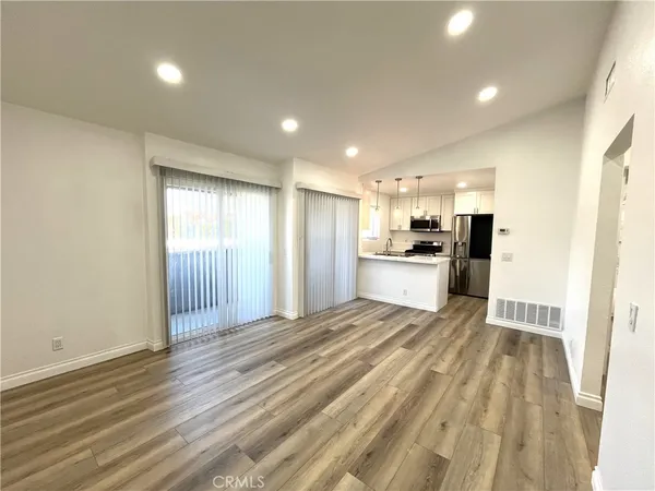 a view of a kitchen with a sink and refrigerator