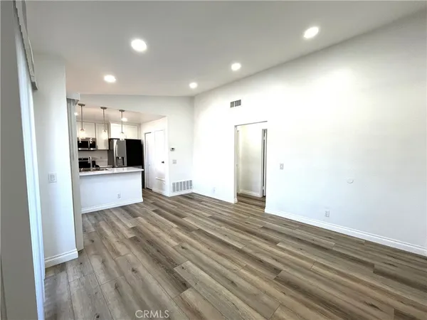 a view of a kitchen with refrigerator and a sink