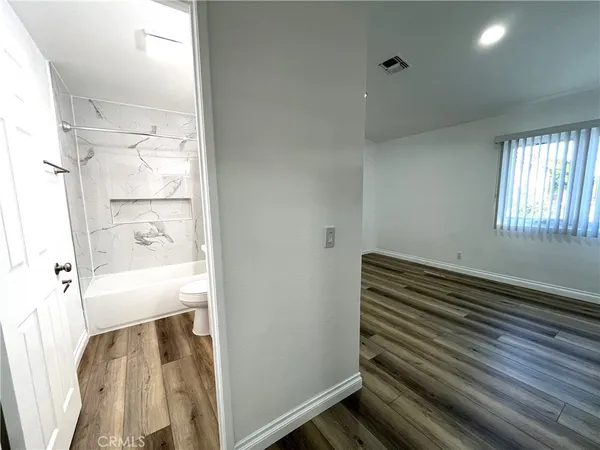a view of room with wooden floor and chair