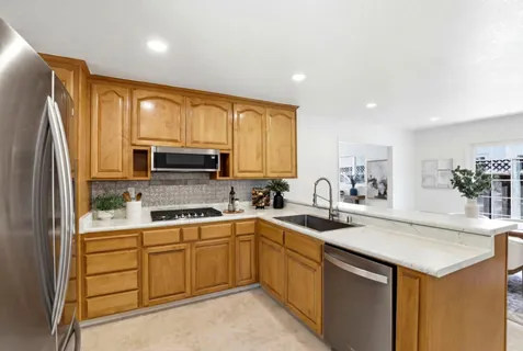 a kitchen with a sink stove and refrigerator