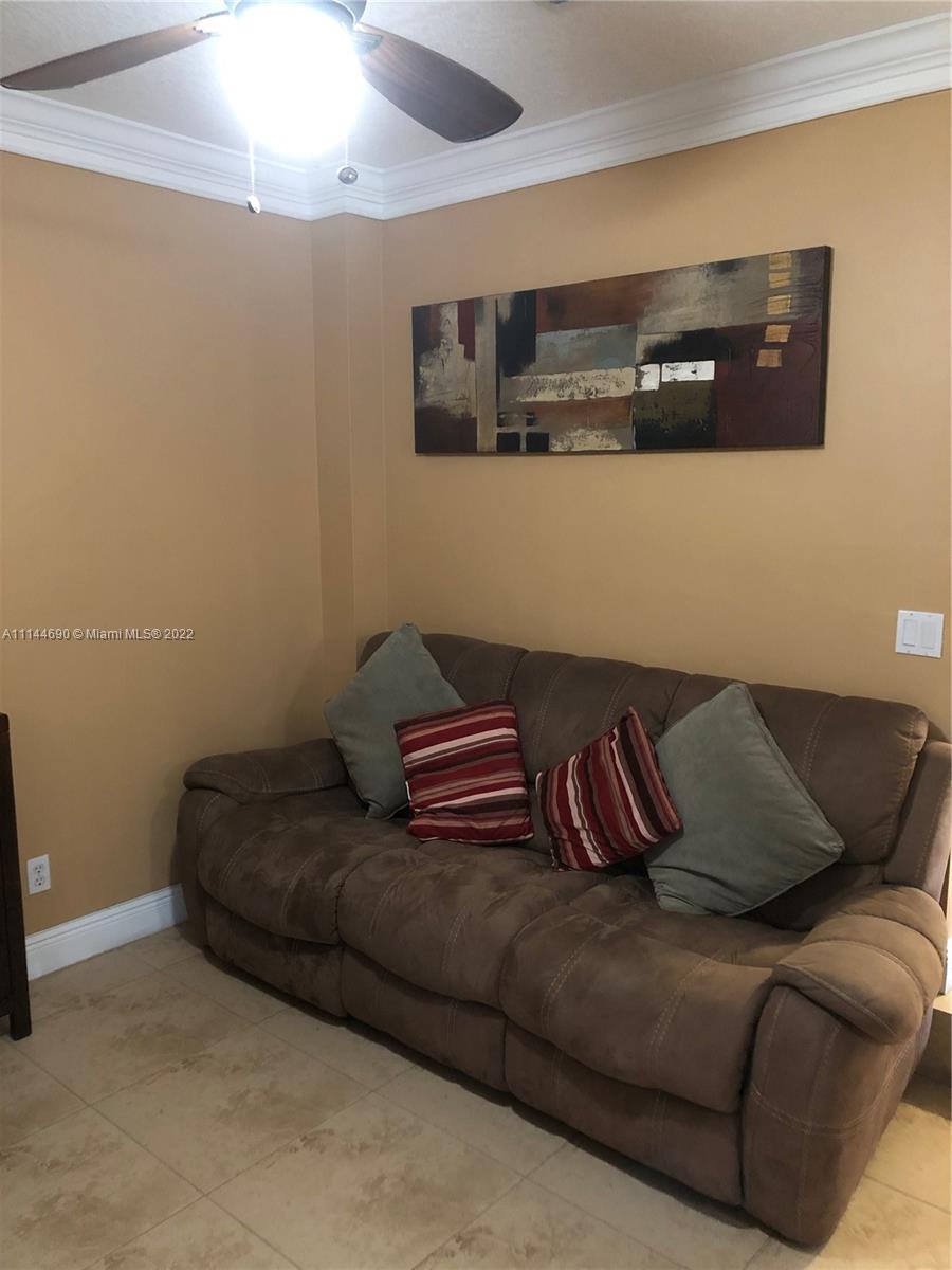 Monarch Lakes Miramar, FL 33027 - Photo 14 of 31 a living room with a couch