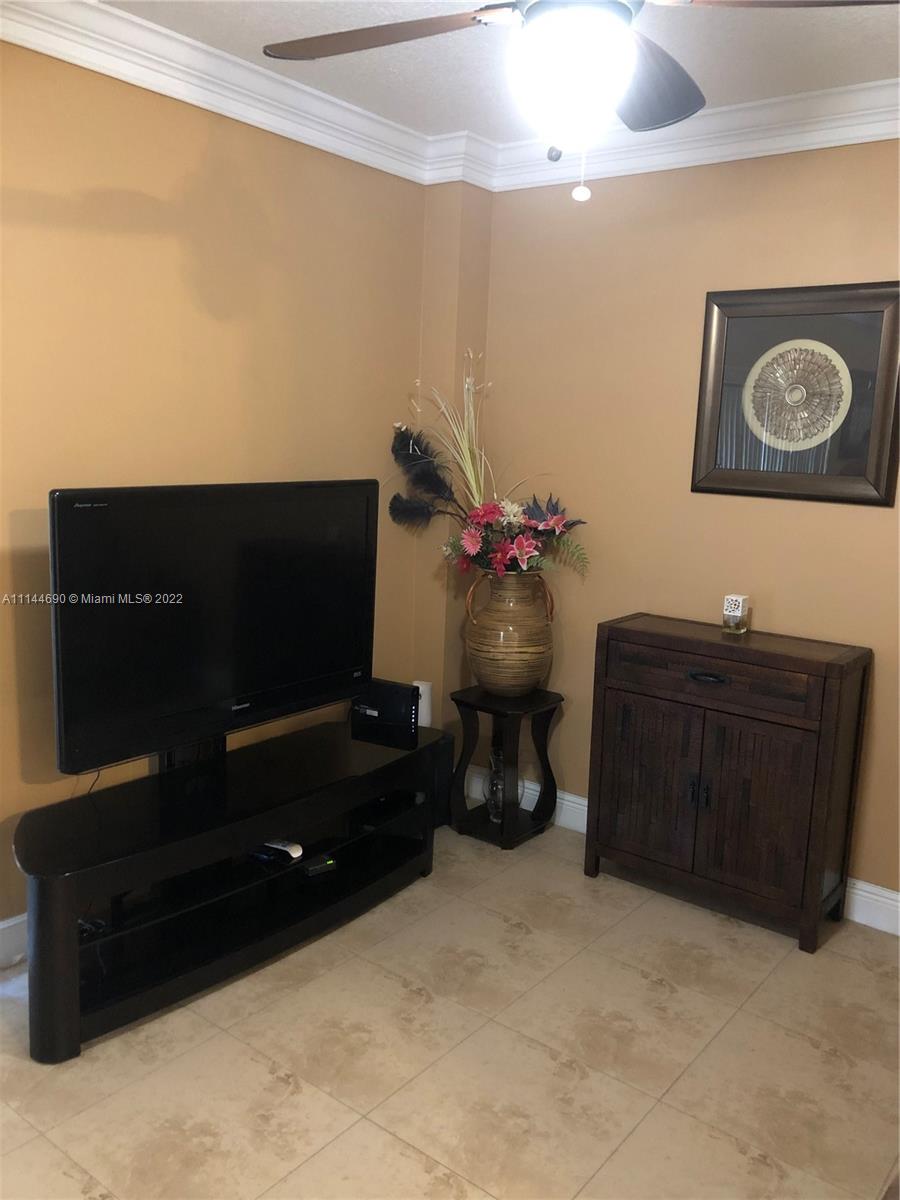 Monarch Lakes Miramar, FL 33027 - Photo 15 of 31 a living room with furniture and a flat screen tv