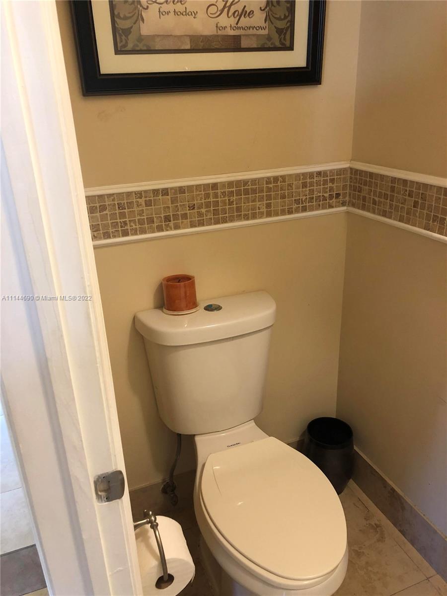 Monarch Lakes Miramar, FL 33027 - Photo 18 of 31 a white toilet sitting next to a shower