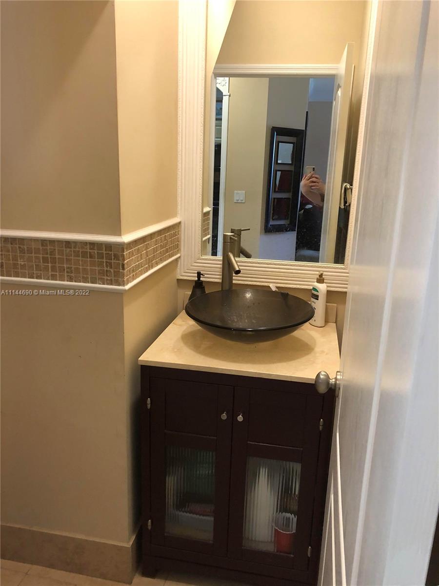 Monarch Lakes Miramar, FL 33027 - Photo 19 of 31 a bathroom with a sink and a mirror