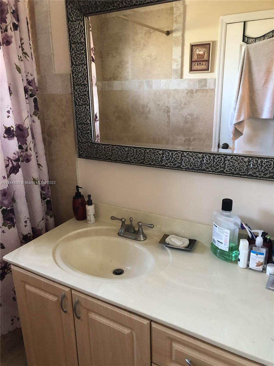 Monarch Lakes Miramar, FL 33027 - Photo 24 of 31 a bathroom with a sink and a mirror