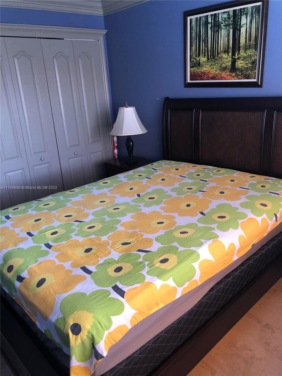 Monarch Lakes Miramar, FL 33027 - Photo 26 of 31 a bedroom with a bed and a painting on the wall