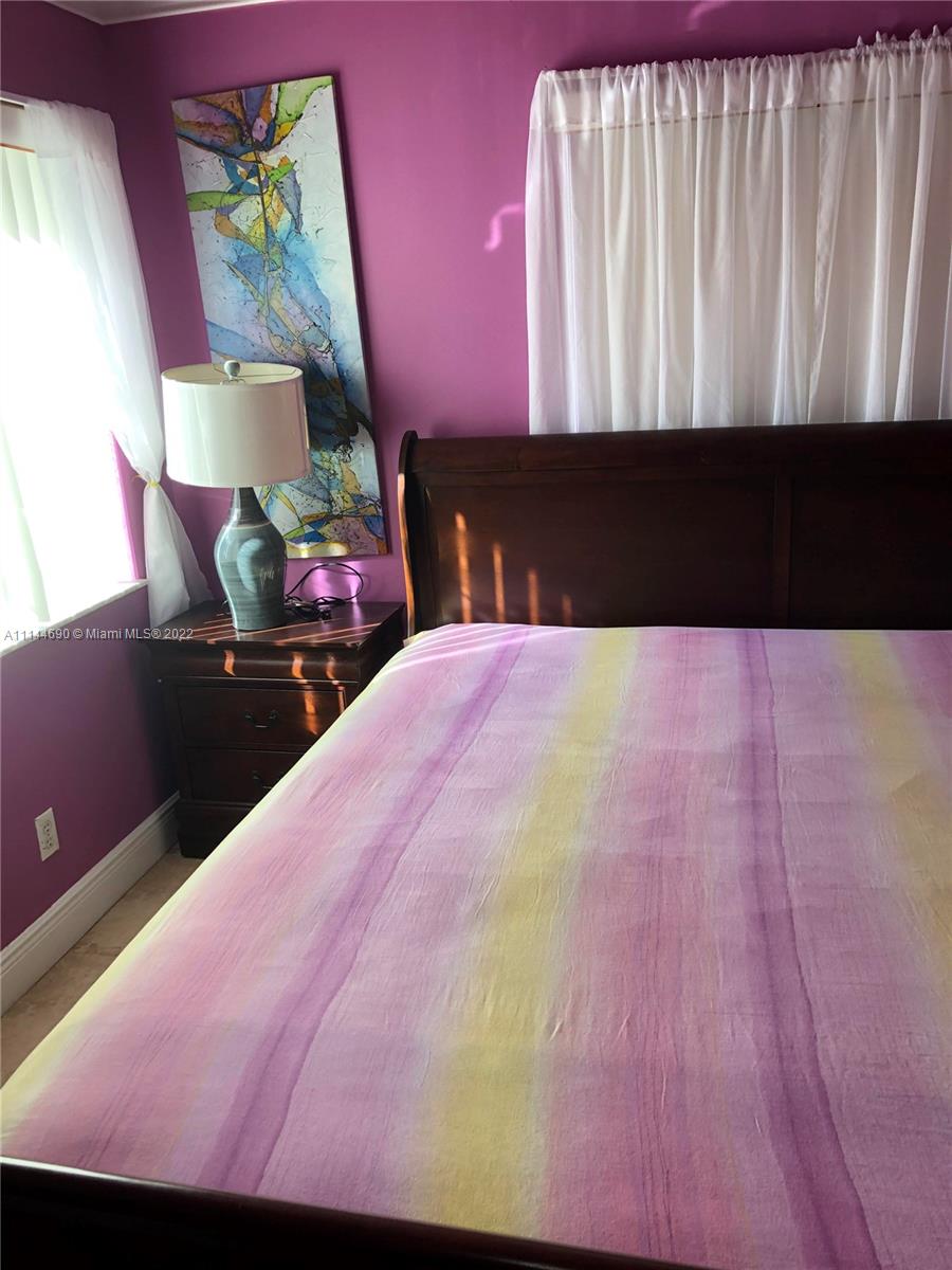 Monarch Lakes Miramar, FL 33027 - Photo 30 of 31 a bed with a black white bedspread and pillows