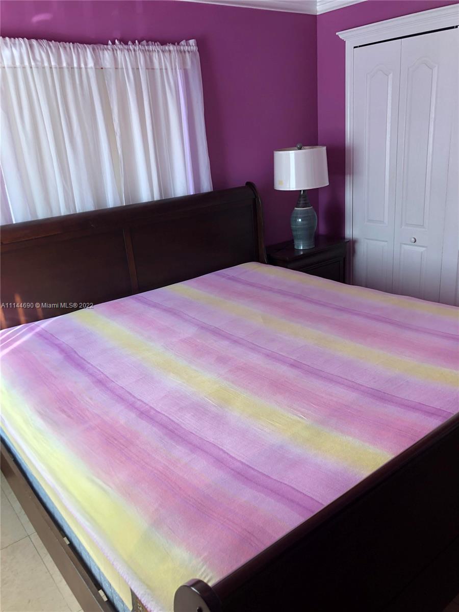 Monarch Lakes Miramar, FL 33027 - Photo 31 of 31 a bedroom with a bed and a dresser