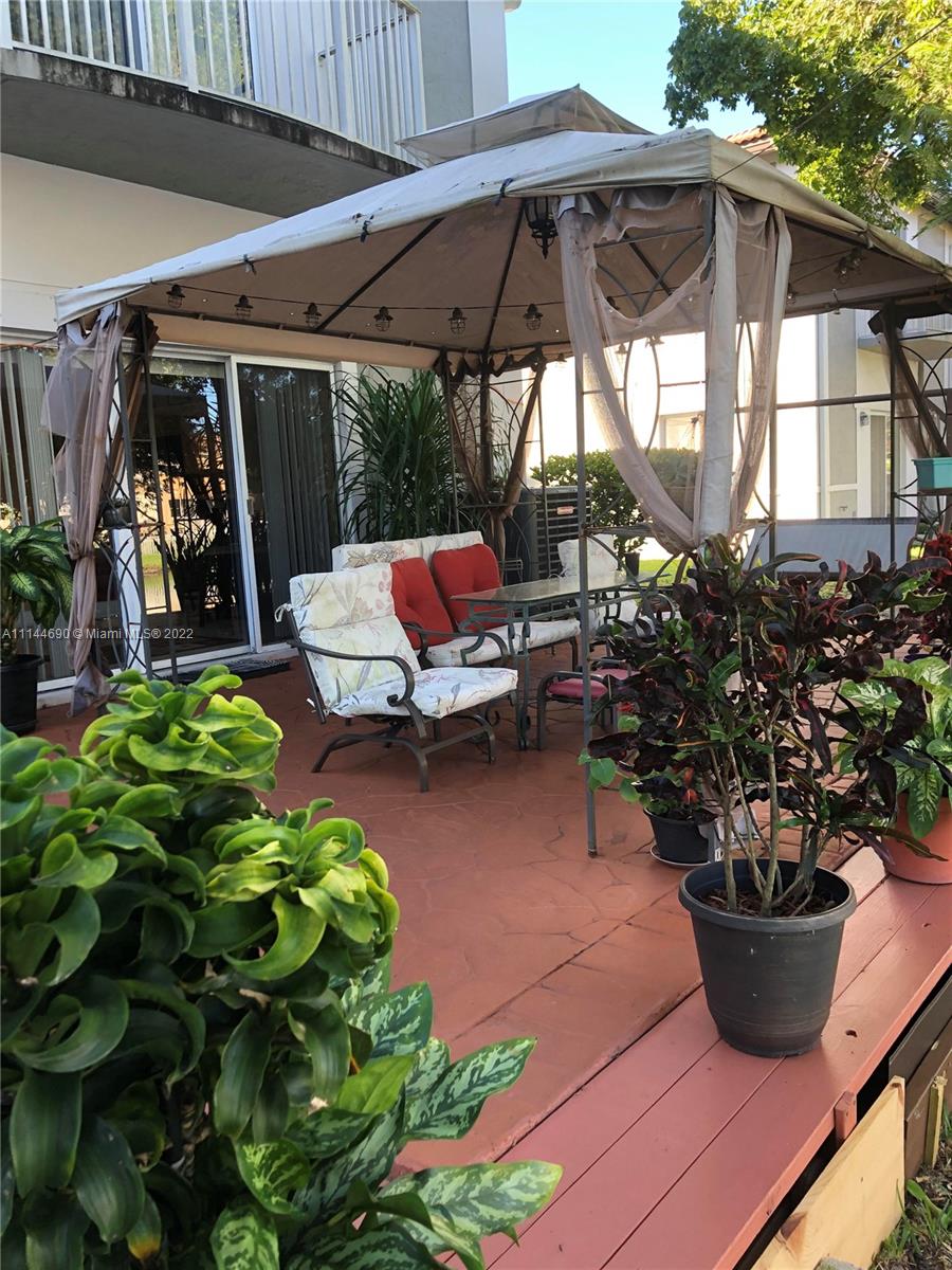 Monarch Lakes Miramar, FL 33027 - Photo 8 of 31 a view of a patio with table and chairs potted plants