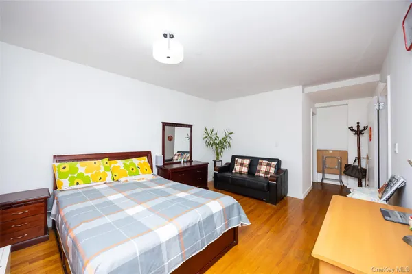 a bedroom with a bed and wooden floor