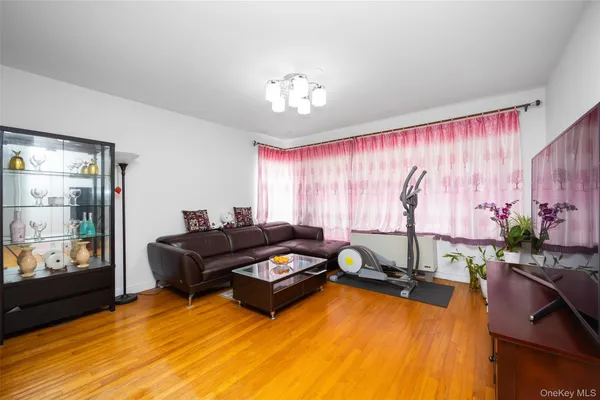 a living room with furniture gym equipment and a chandelier