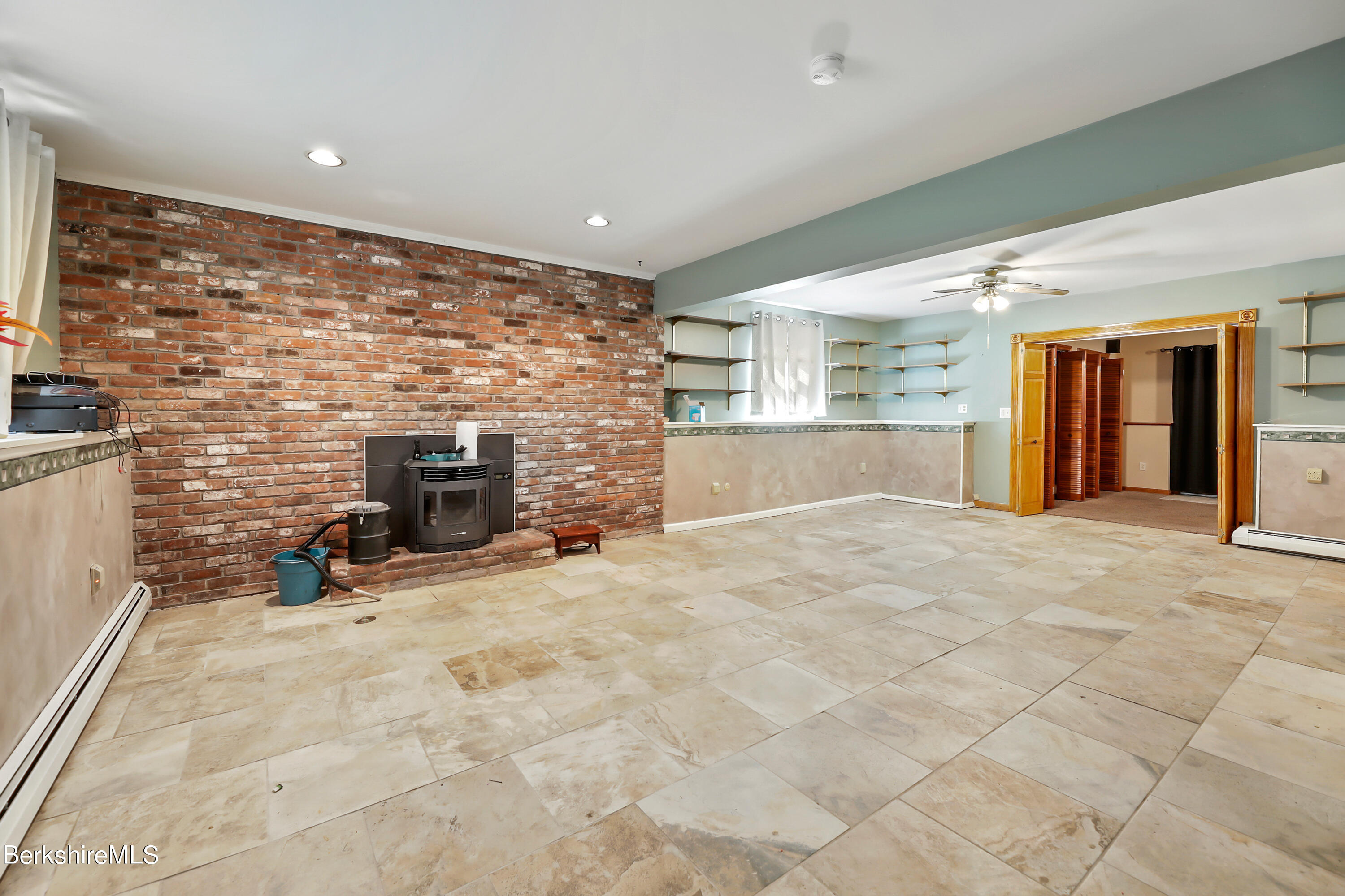 31 Olsen Road Lanesborough, MA 01237 - Photo 19 of 31 a view of empty room with fireplace and windows