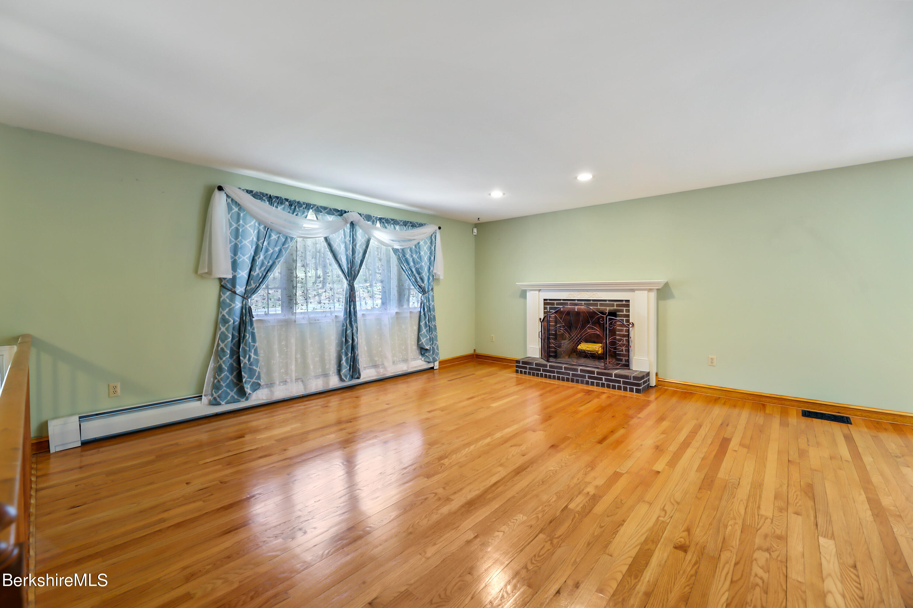 31 Olsen Road Lanesborough, MA 01237 - Photo 5 of 31 a view of empty room with wooden floor and fireplace