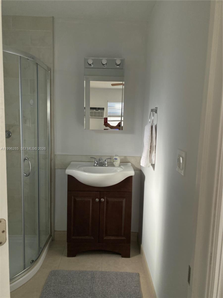 2481 Southwest 11th Street, Unit A Miami, FL 33135 - Photo 6 of 7 a bathroom with a sink and a mirror