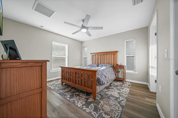 a bed sitting in a bedroom next to a window