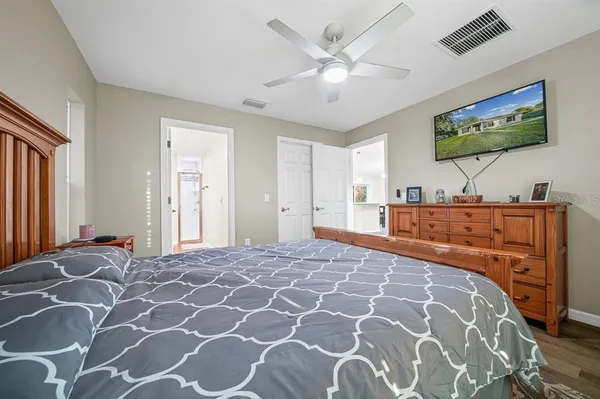 a bedroom with a large bed and a flat screen tv