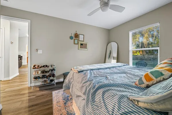 a bedroom with a bed and a chandelier